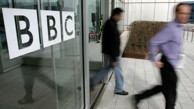 People leave the BBC building, in the corporation&#039;s West London headquarters, 21 March 2005. The BBC is to axe 2050 jobs in a second wave of cuts to save hundreds of millions of pounds, the c