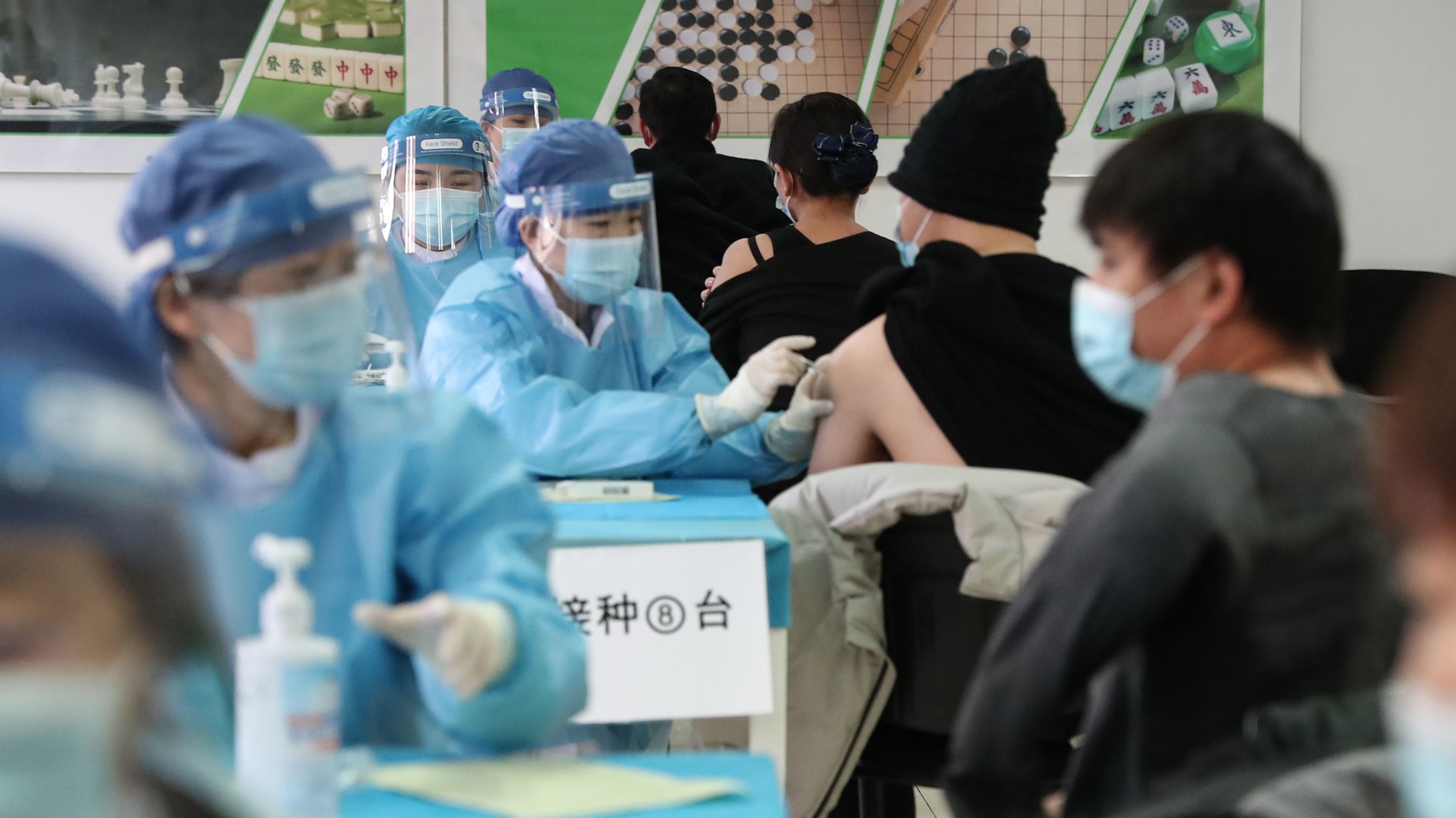 People get their vaccinations at a temporary centre in Beijing, China
