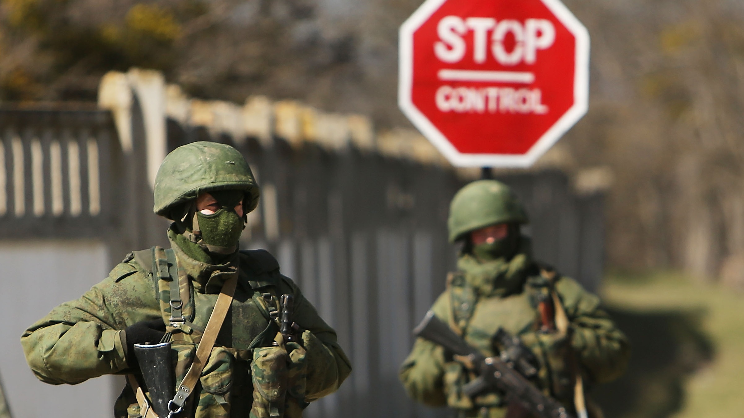 Armed soldiers without identifying insignia stand guard outside a Ukrainian military base in Crimea