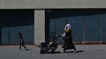 A Muslim woman walks down a street in London