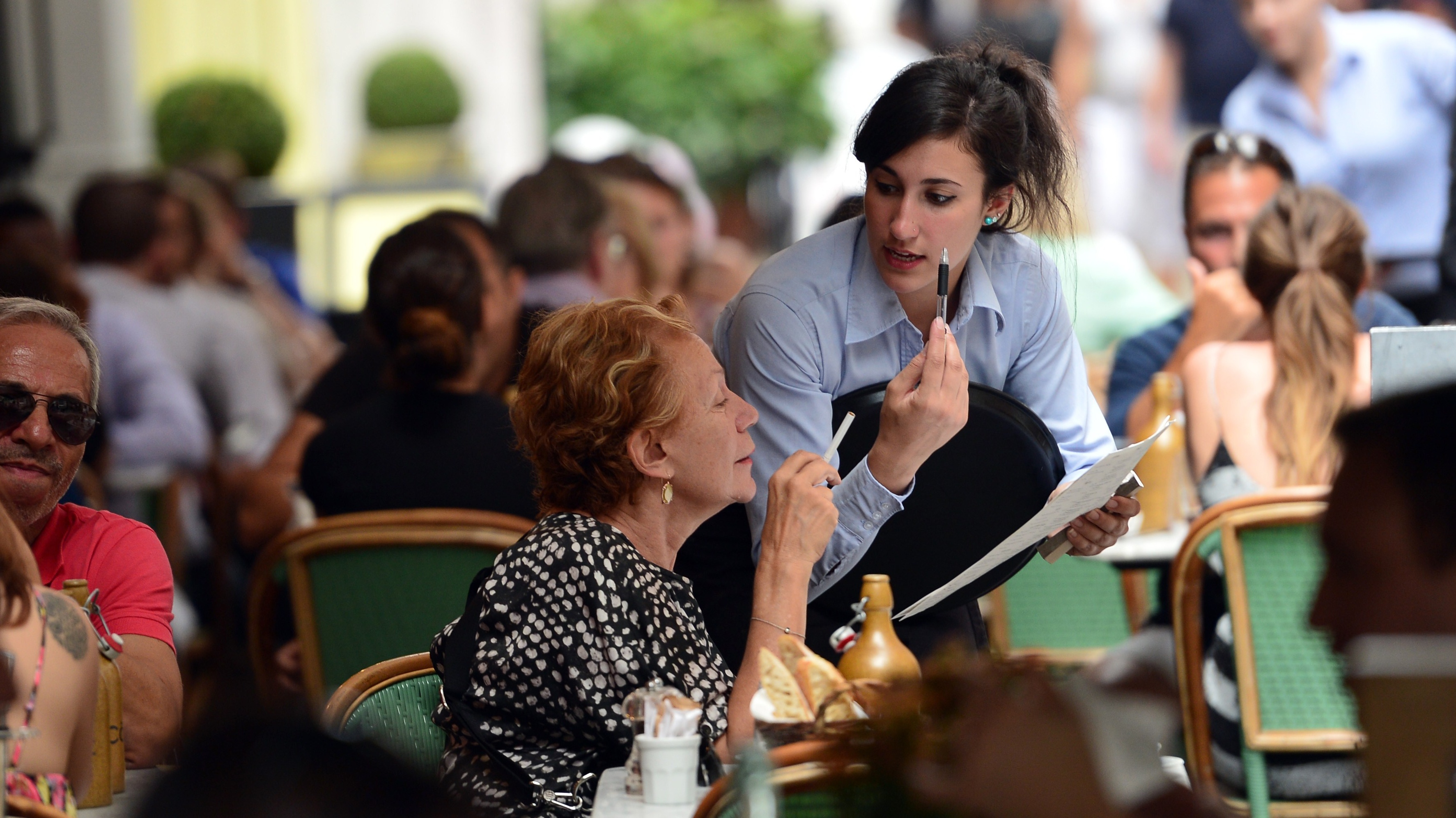 Waitress takes an order in central London restaurant