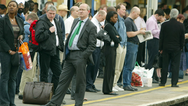 Passengers wait for trains to arrive, London