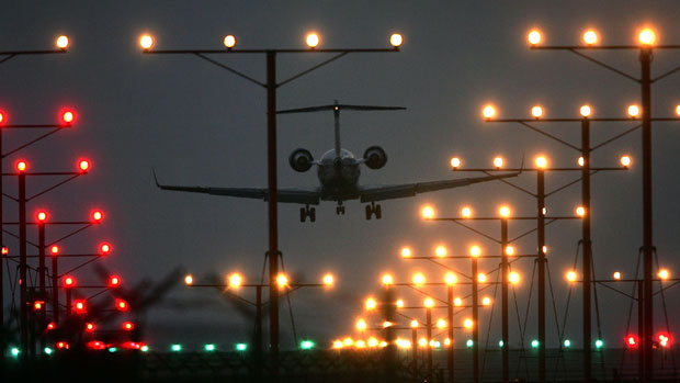 A plane lands at night