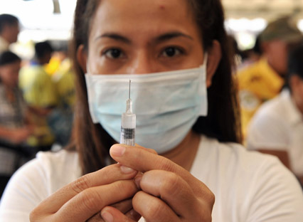 A nurse prepares a vaccination