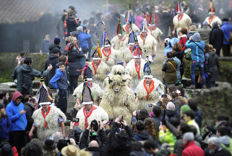 Bellringers, known as &quot;Joaldunak&quot; in Basque language and a man dressed as Hartza (bear) (C) march with big cowbells tied to their backs during the ancient carnival of Zubieta, in the northern