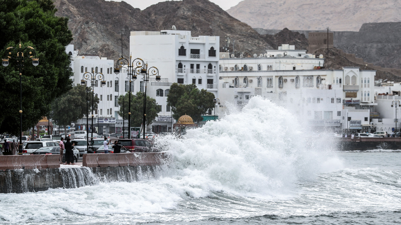 Wave breaks over promenade in Muscat