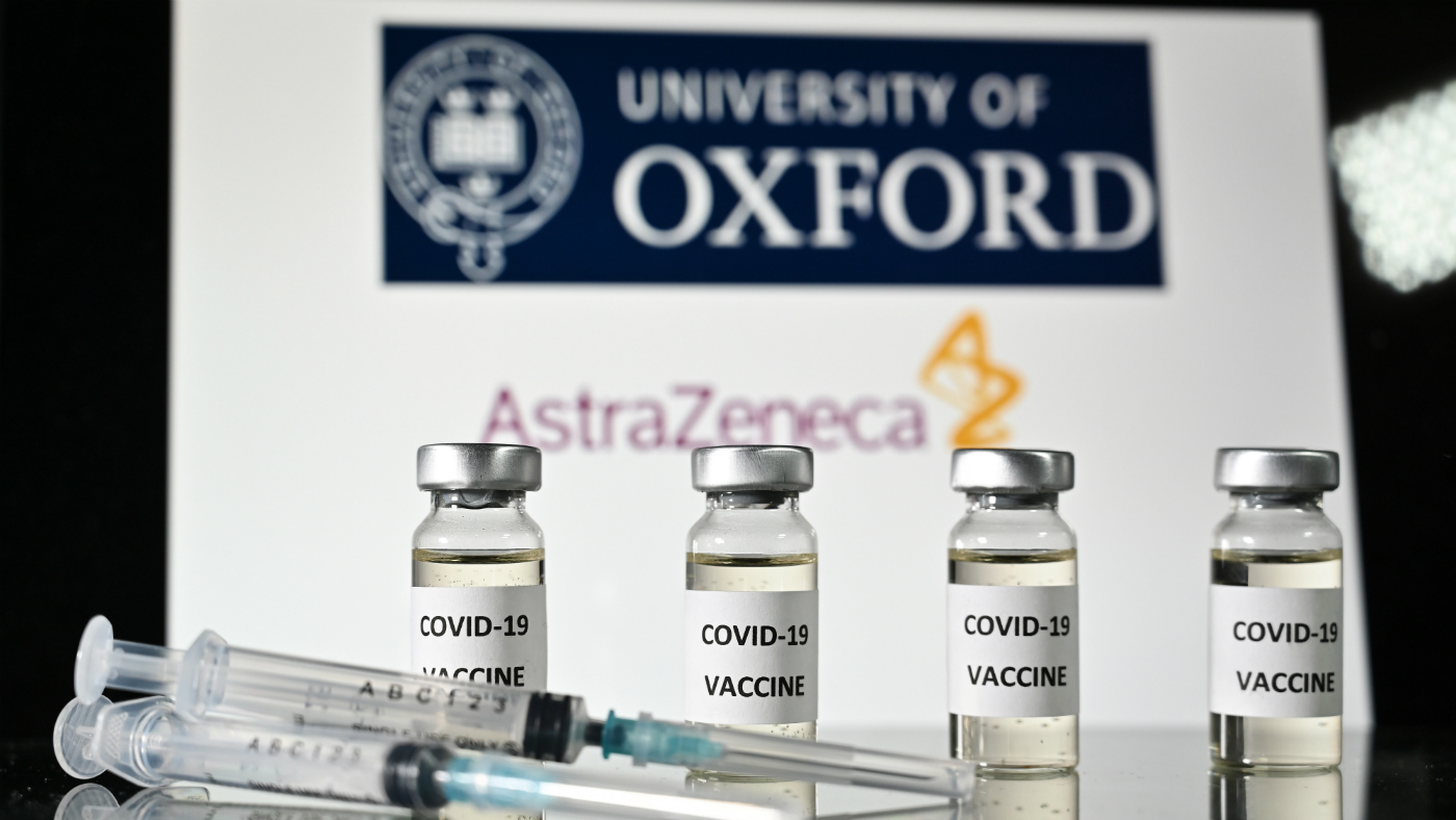 Vials of the Oxford Covid-19 vaccine in front of a sign for Oxford University