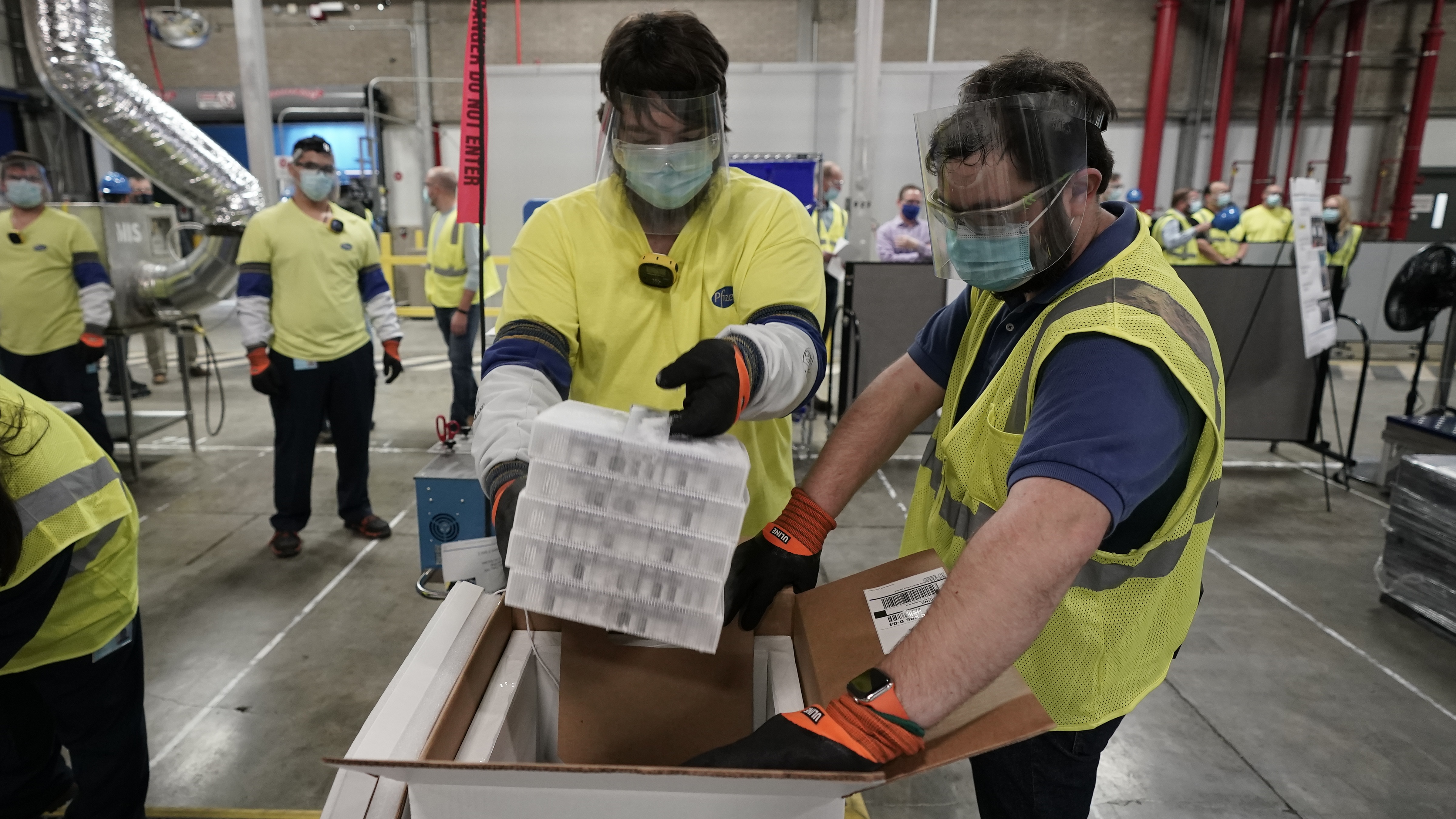 Boxes containing the Pfizer vaccine are prepared for shipping