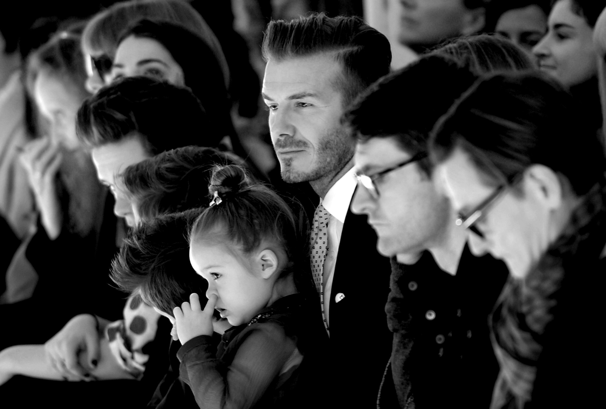 Soccer great David Beckham with his daughter Harper look on as models present the fashions of Victoria Beckham during the Mercedes-Benz Fashion Week Fall/Winter 2014 shows February 9, 2014 in