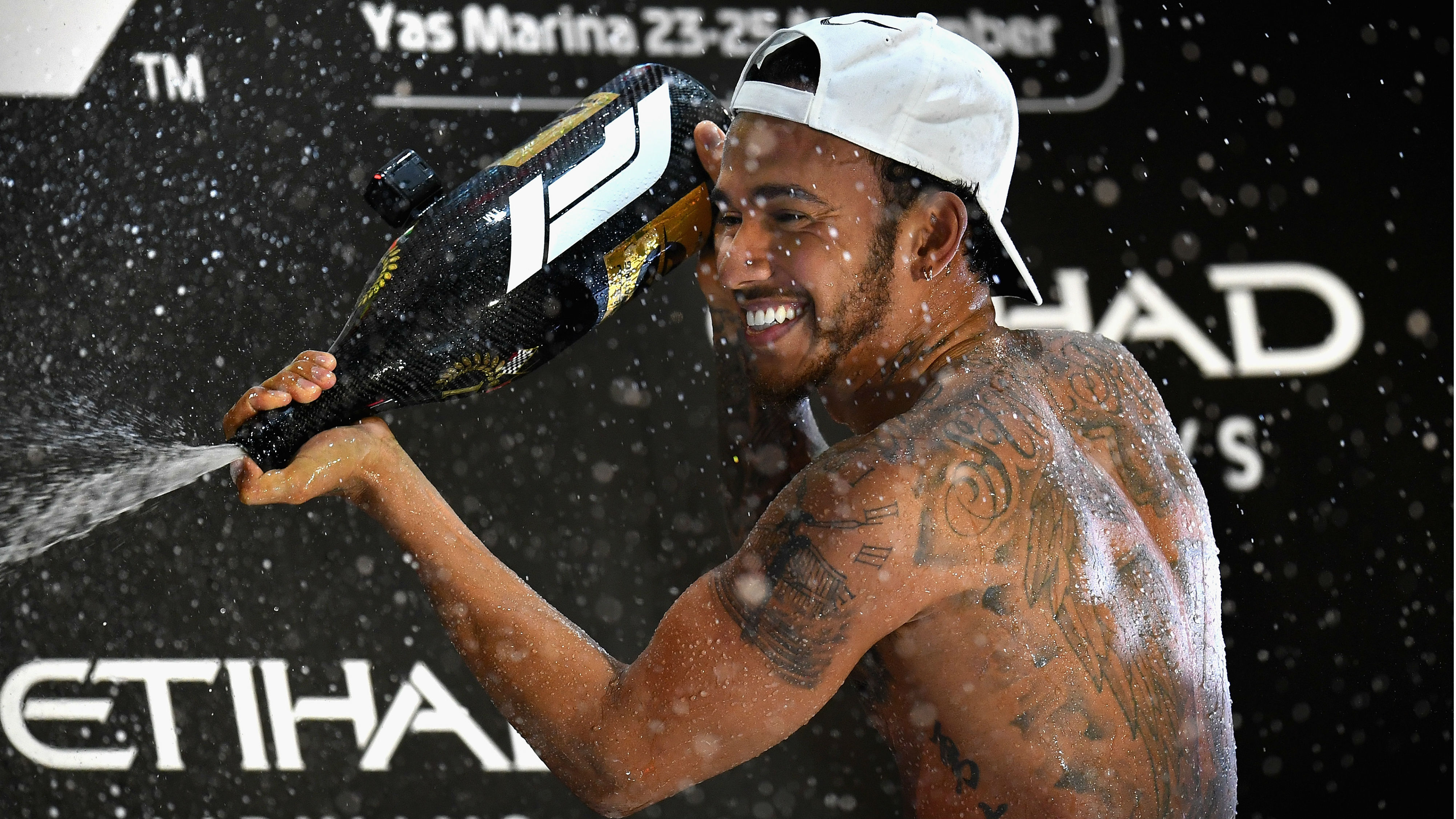 Lewis Hamilton shows off his tattoos after another GP win