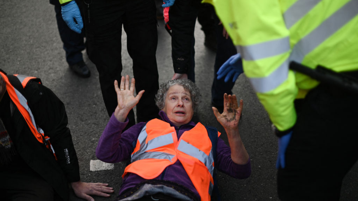 Insulate Britain protester talks to police