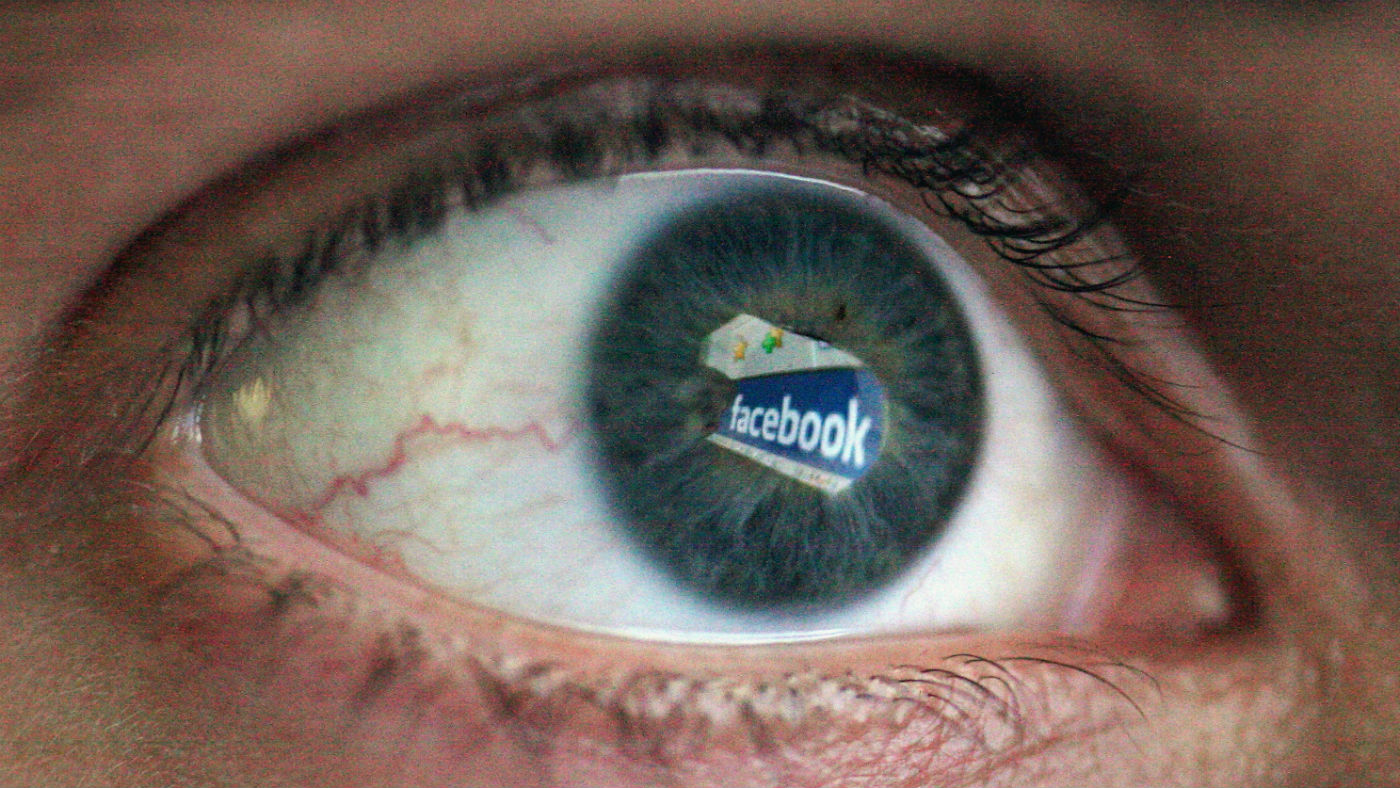 The Facebook logo reflected in an eye