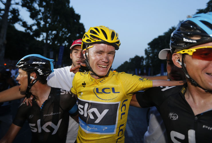 Tour de France 2013 winner Britain&#039;s Christopher Froome (C) celebrates with teammates on the Champs-Elysee avenue in Paris, after finishing the 133.5 km twenty-first and last stage of the 100