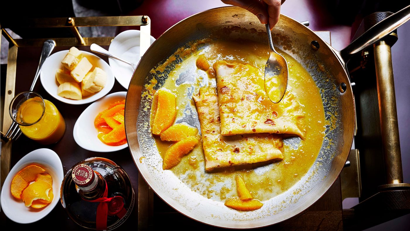 Classic crêpes suzette is flamed tableside