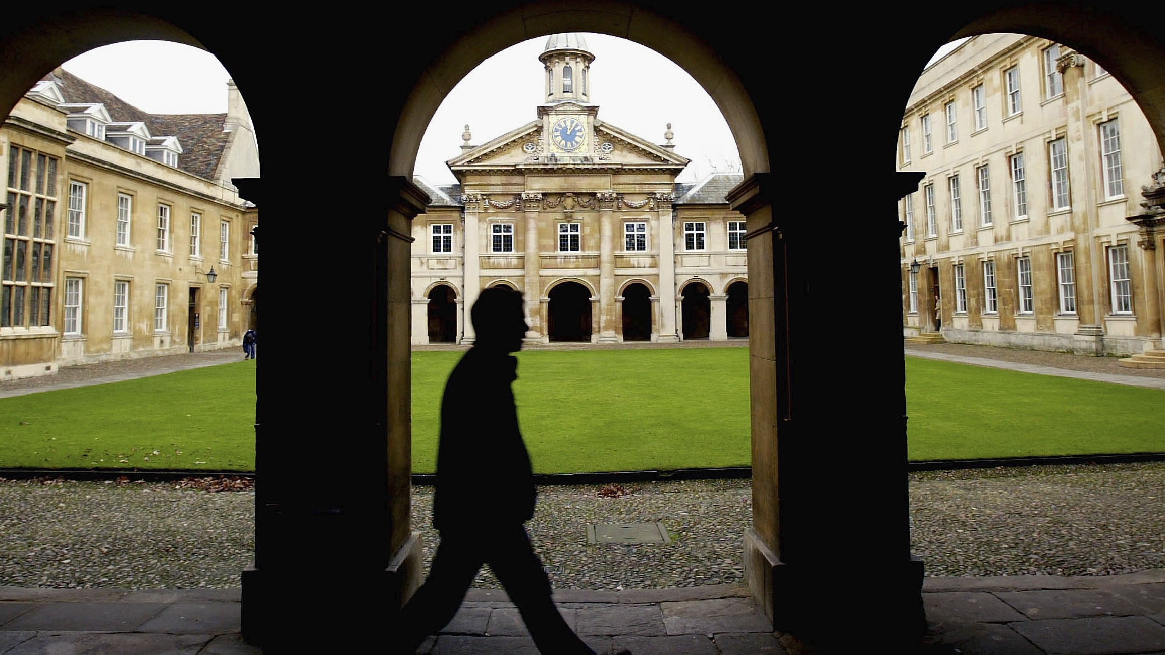 A student walks through Emmanuel College, University of Cambridge