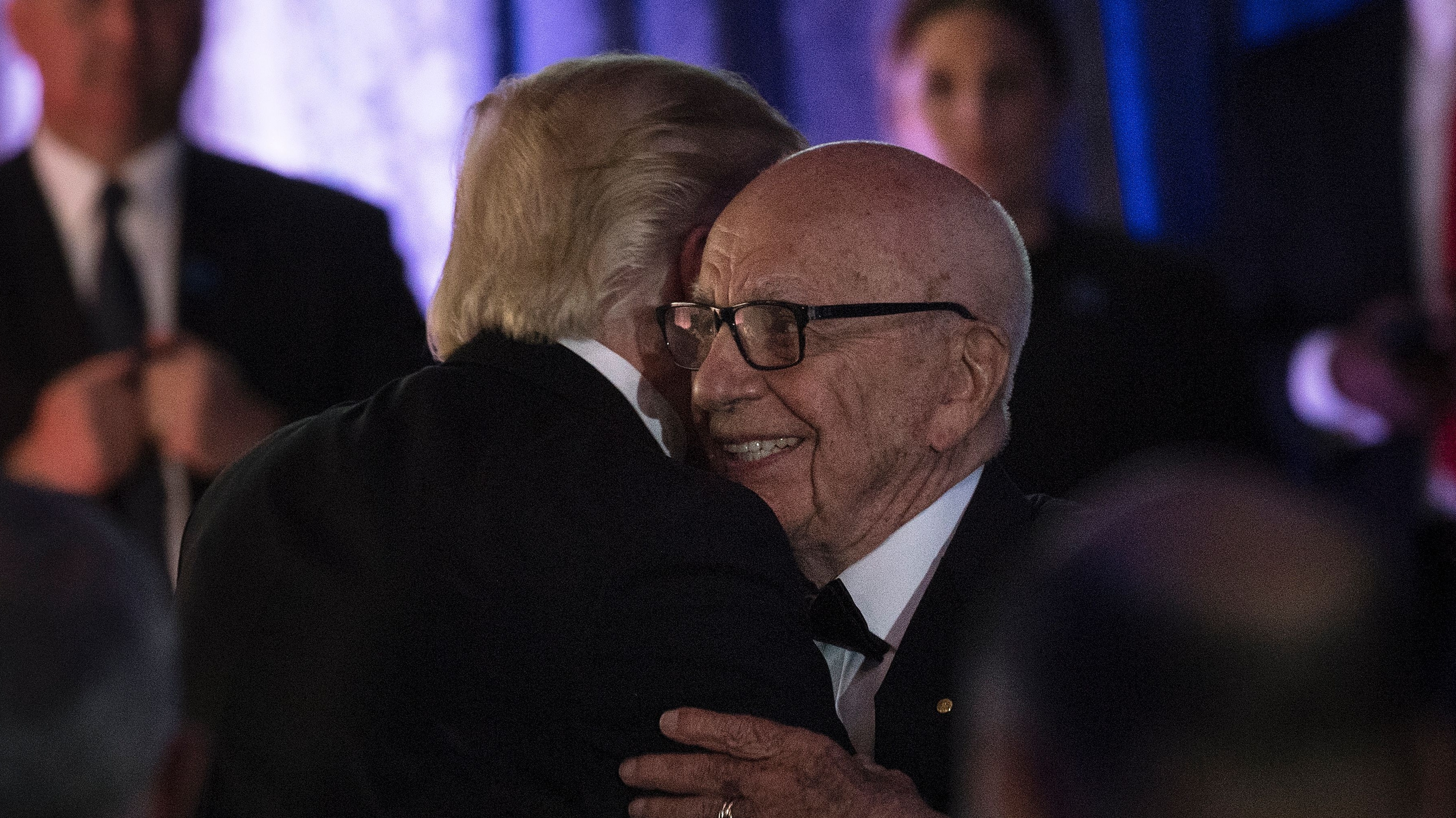 Donald Trump and Rupert Murdoch embrace at a  dinner to commemorate the 75th anniversary of the Battle of the Coral Sea.