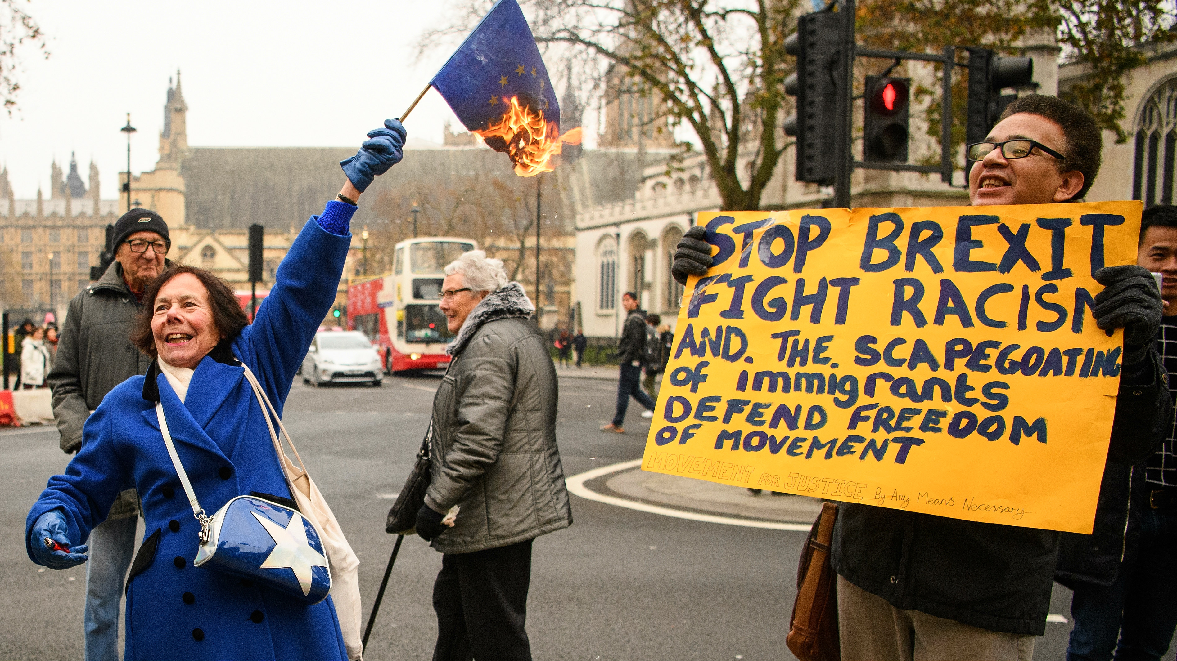 A woman burns an EU flag outside the Supreme Court in London during the landmark Brexit hearing