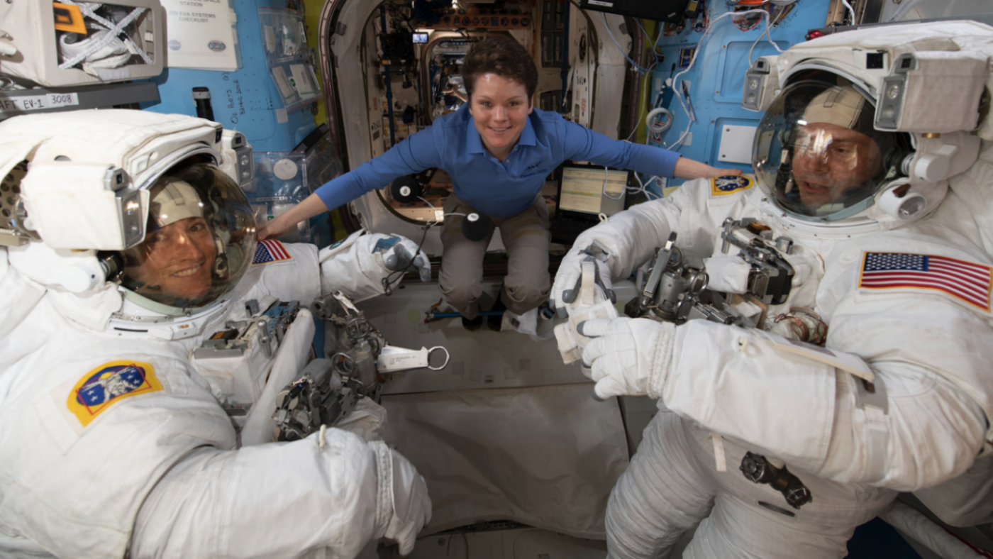 Christina H. Koch (centre) helps Nasa colleagues Anne McClain (left) and Nick Hague (right) ahead of their 22 March spacewalk