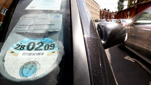 A tax disc is displayed on a car in London