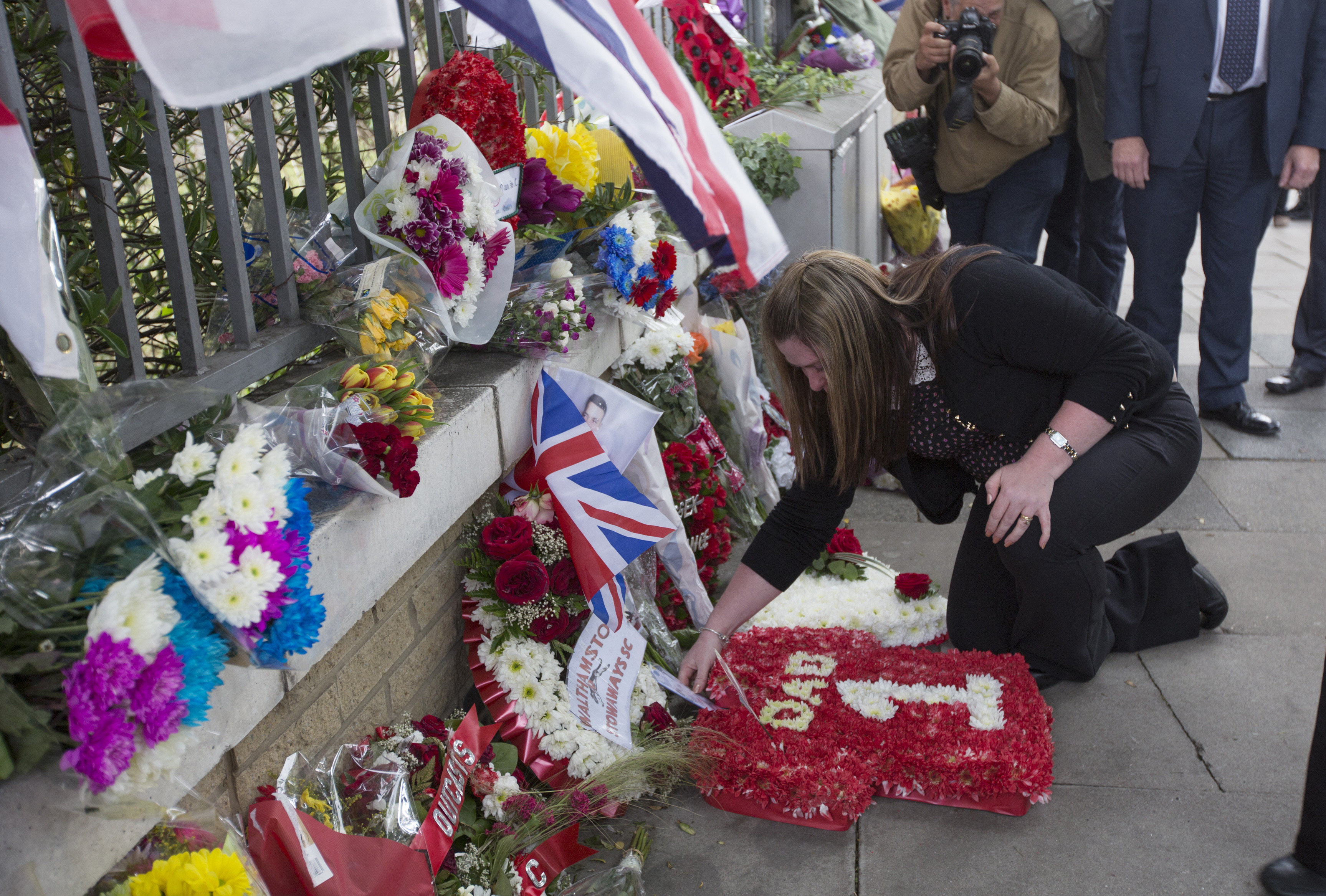 WOOLWICH, ENGLAND - MAY 22:Rebecca Rigby, the widow of murdered fusilier Lee Rigby, lays a wreath at the scene of Mr Rigby&#039;s murder, adjacent to the Royal Artillery Barracks, on the first ann
