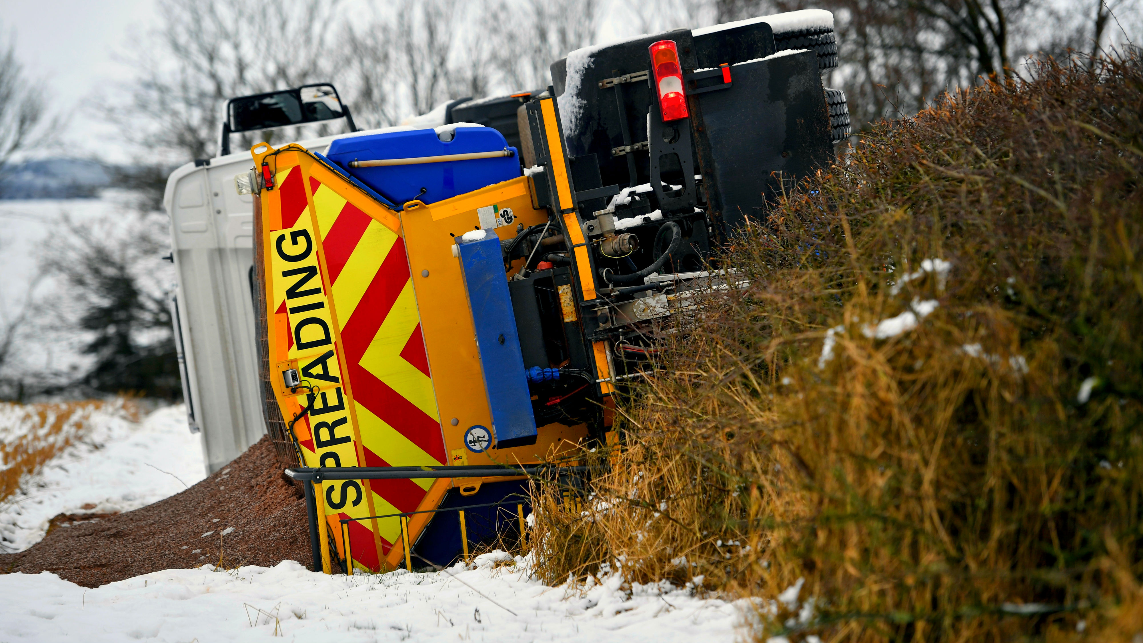 A gritting lorry overturns near Balfron, in Sterlingshire, as Storm Doris brings weather chaos to the UK