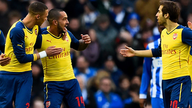 Theo Walcott with his Arsenal teammates celebrate after scoring a goal against Brighton