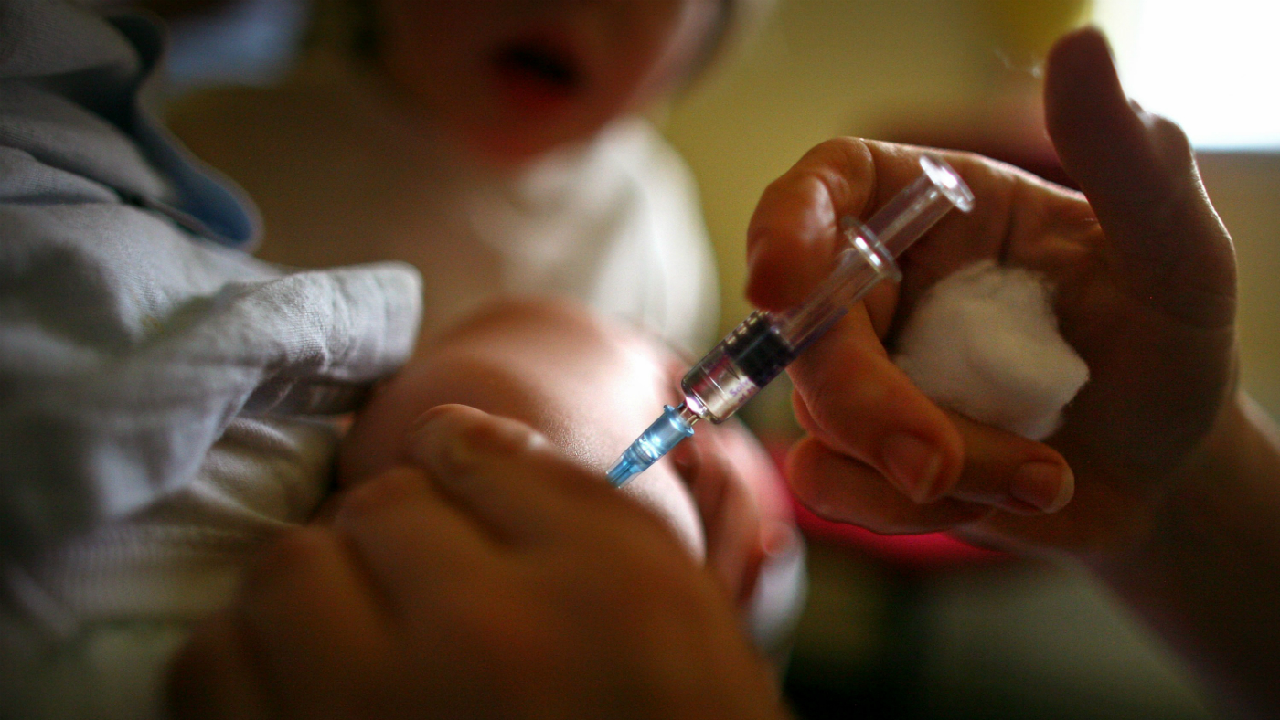 Vaccine is administered to a child.