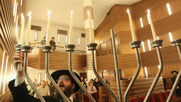 Rabbi Yehuda Teichtal lights a menorah on the sixth day of Hanukkah at the Orthodox synagogue at the Chabad-Lubavitch Jewish Education Center on December 6, 2010