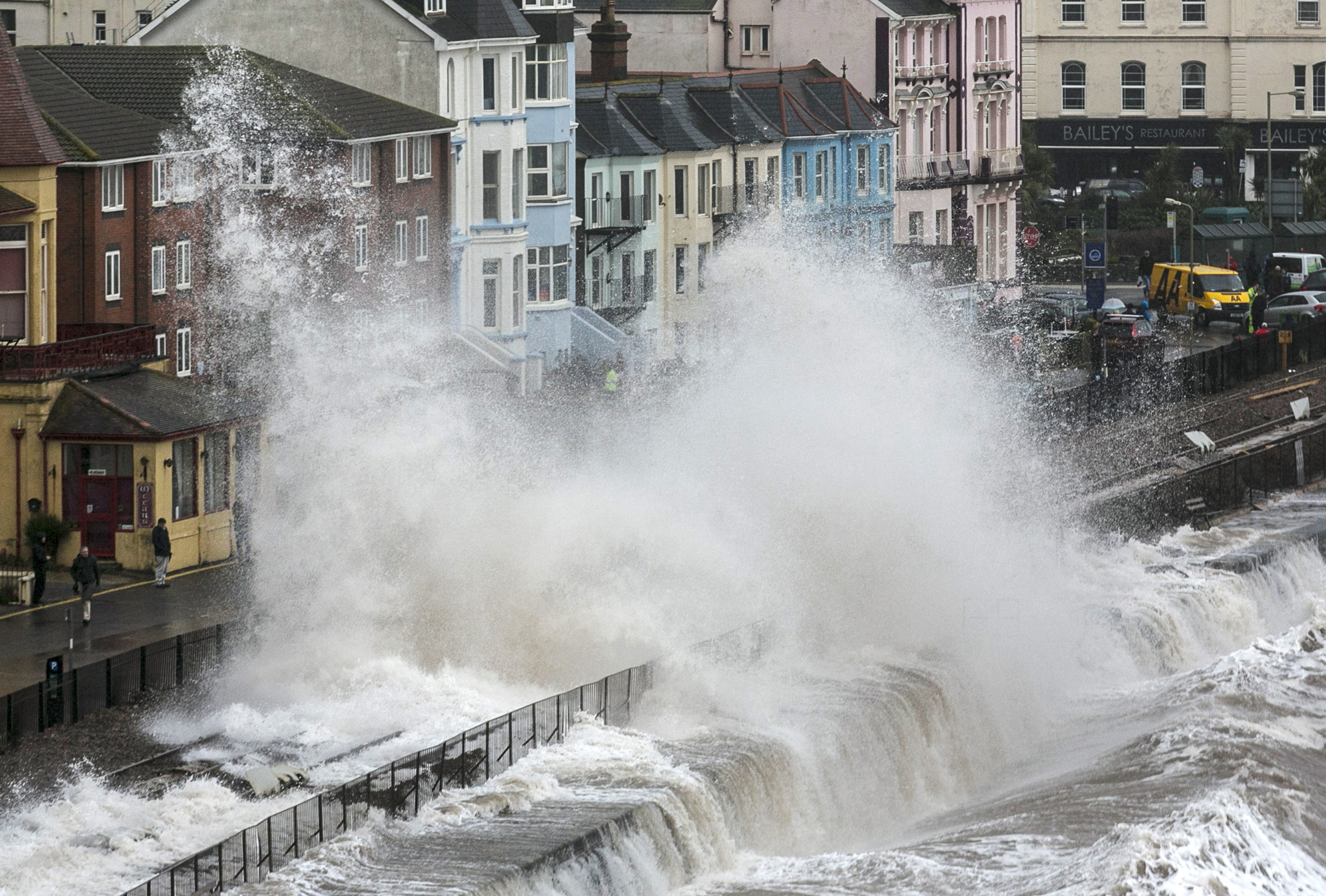 DAWLISH, UNITED KINGDOM - FEBRUARY 05:Waves crash against the seafront and the railway line that has been closed due to storm damage at Dawlish on February 5, 2014 in Devon, England. High tid