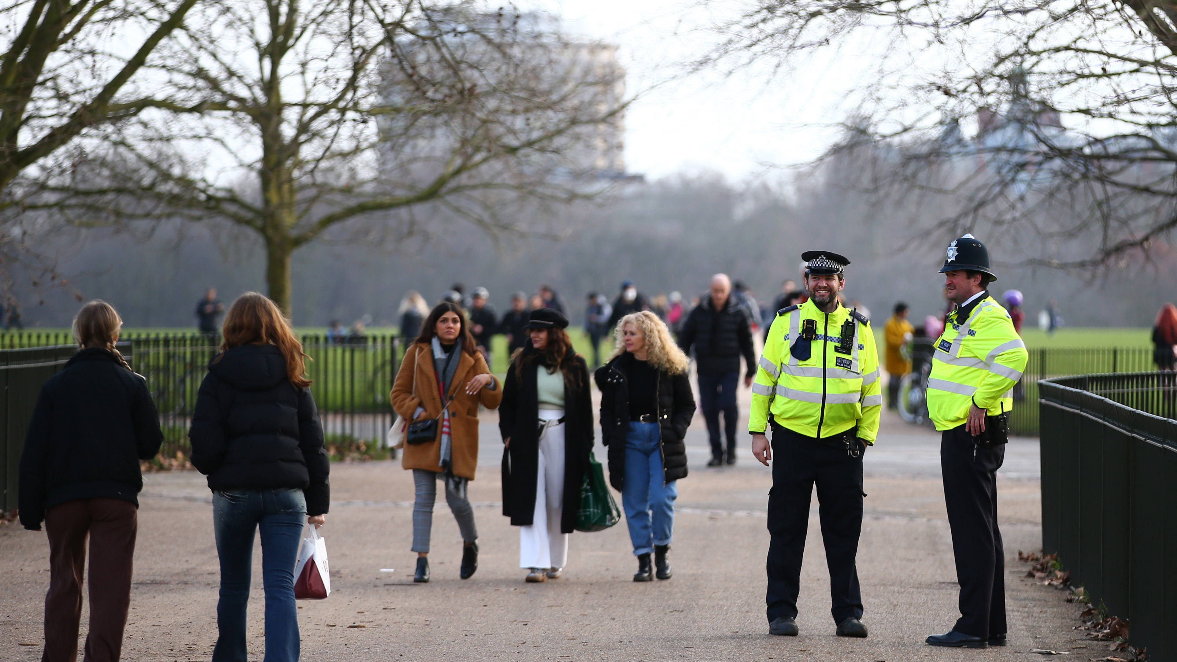 Metropolitan Police officers patrol as people walk in Hyde Park