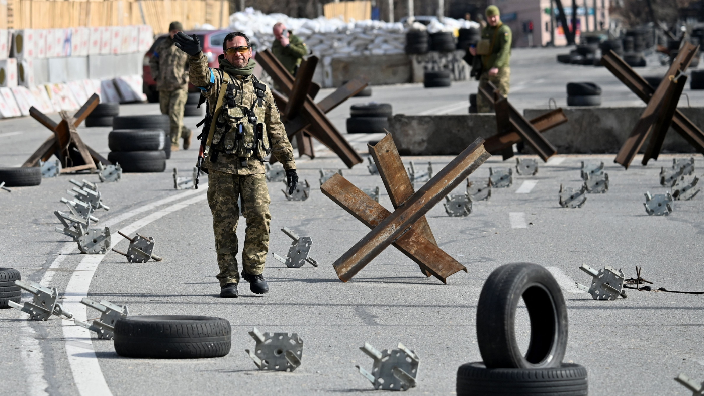 Ukrainian soldiers guard a checkpoint outside Kyiv