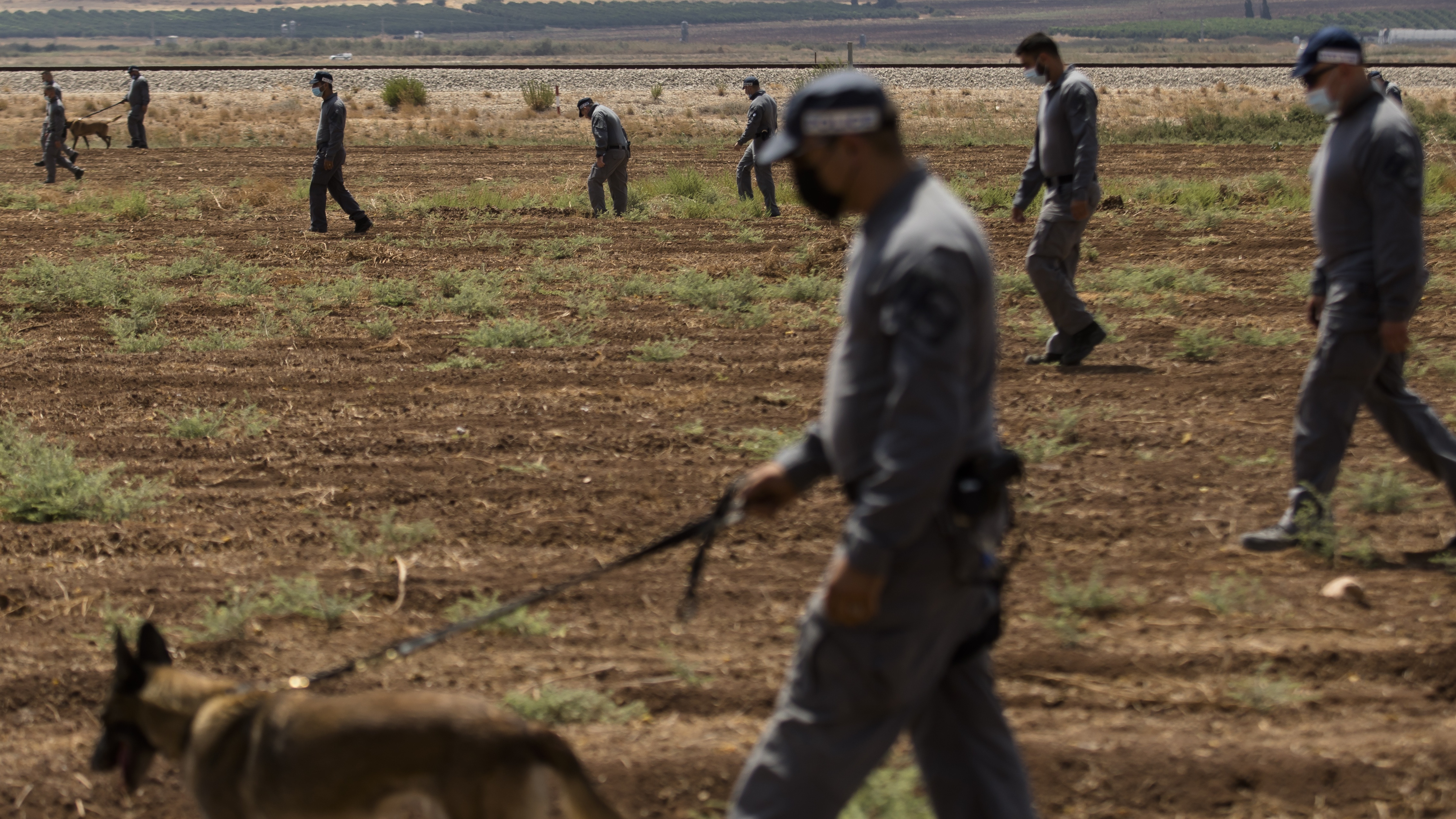 Israeli prison officers conduct a search after the break-out