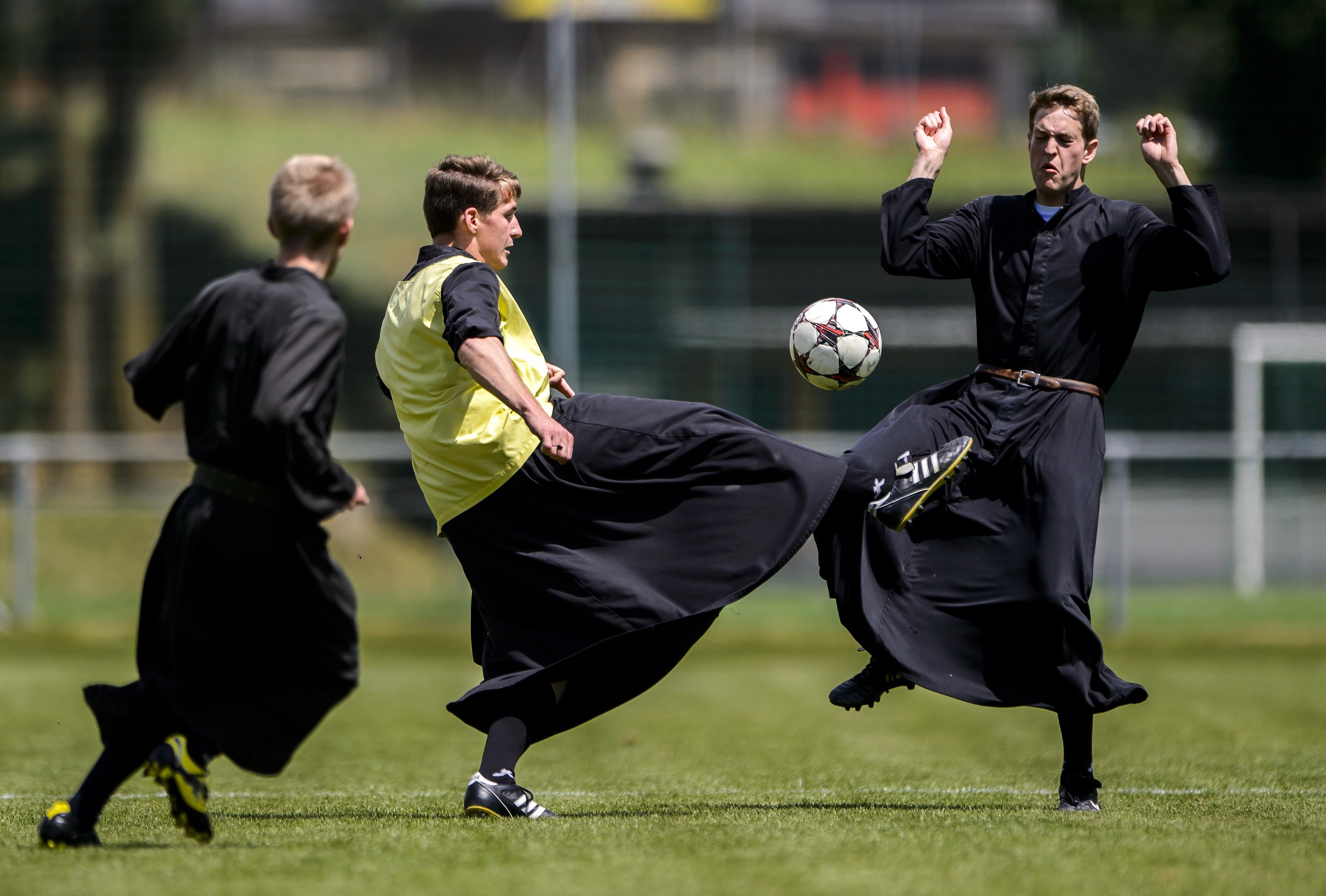 Seminarians of the International Seminary of Saint Pius X vie wearing their cassocks for the ball during a football game on May 25, 2014 in Riddes, Western Switzerland. After a whole week ded