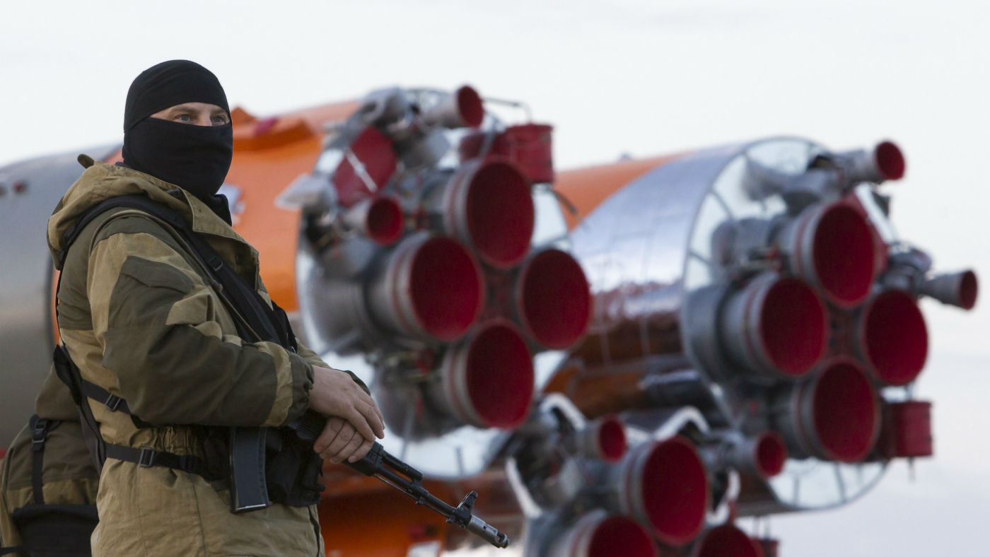 A Russian solider stands guard over the Soyuz TMA-14M spacecraft
