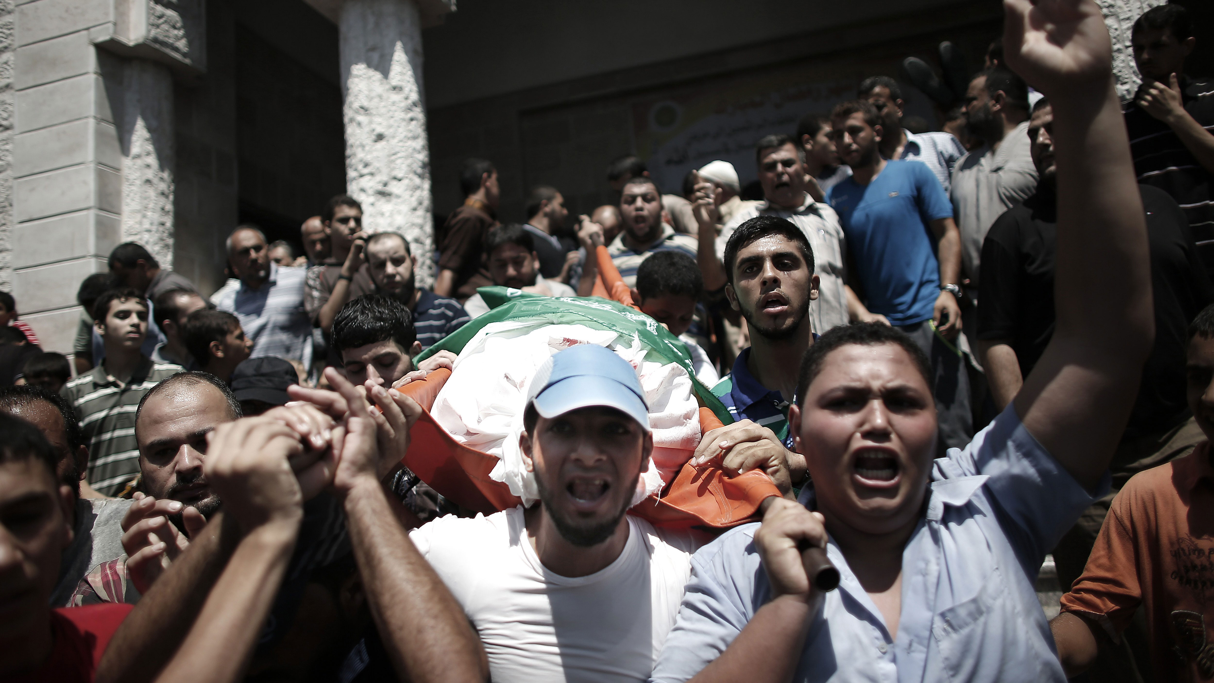 Palestinians carry the body of Mohammad Deif