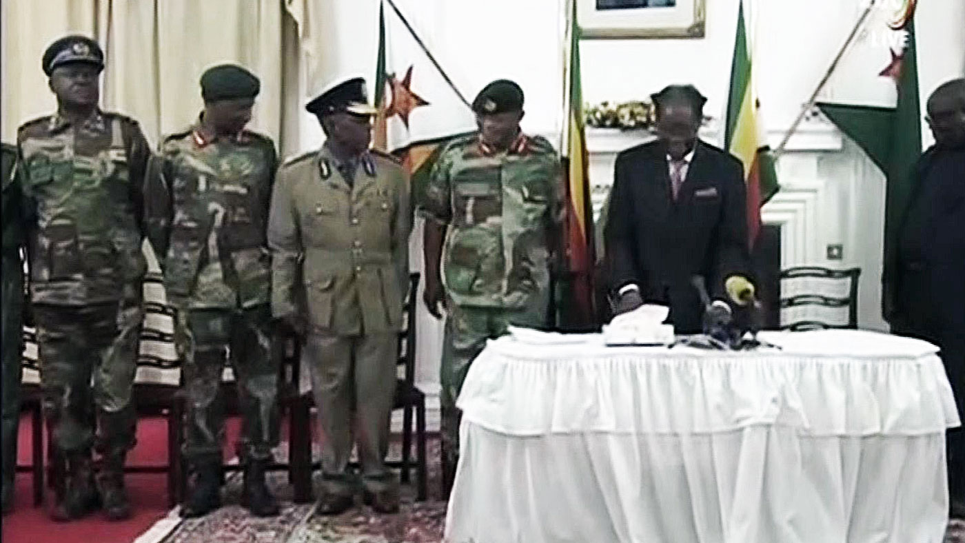 Robert Mugabe, flanked by Zimbabwe Defence Force officers, prepares for his TV address