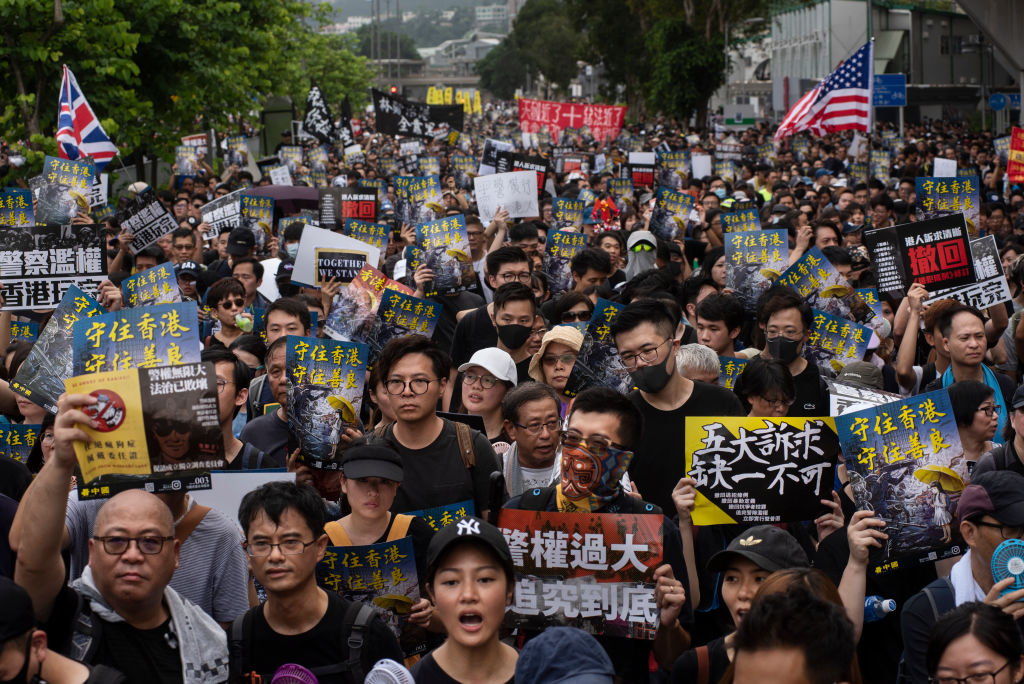 HONG KONG, CHINA - 2019/07/14: Huge crowd of pro democracy protesters with placards during the demonstration.Thousands of pro-democracy demonstrators took to the street once again in a new wa