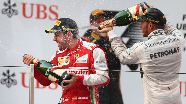SHANGHAI, CHINA - APRIL 14:Race winner Fernando Alonso (L) of Spain and Ferrari celebrates on the podium with third placed Lewis Hamilton (R) of Great Britain and Mercedes GP following the Ch