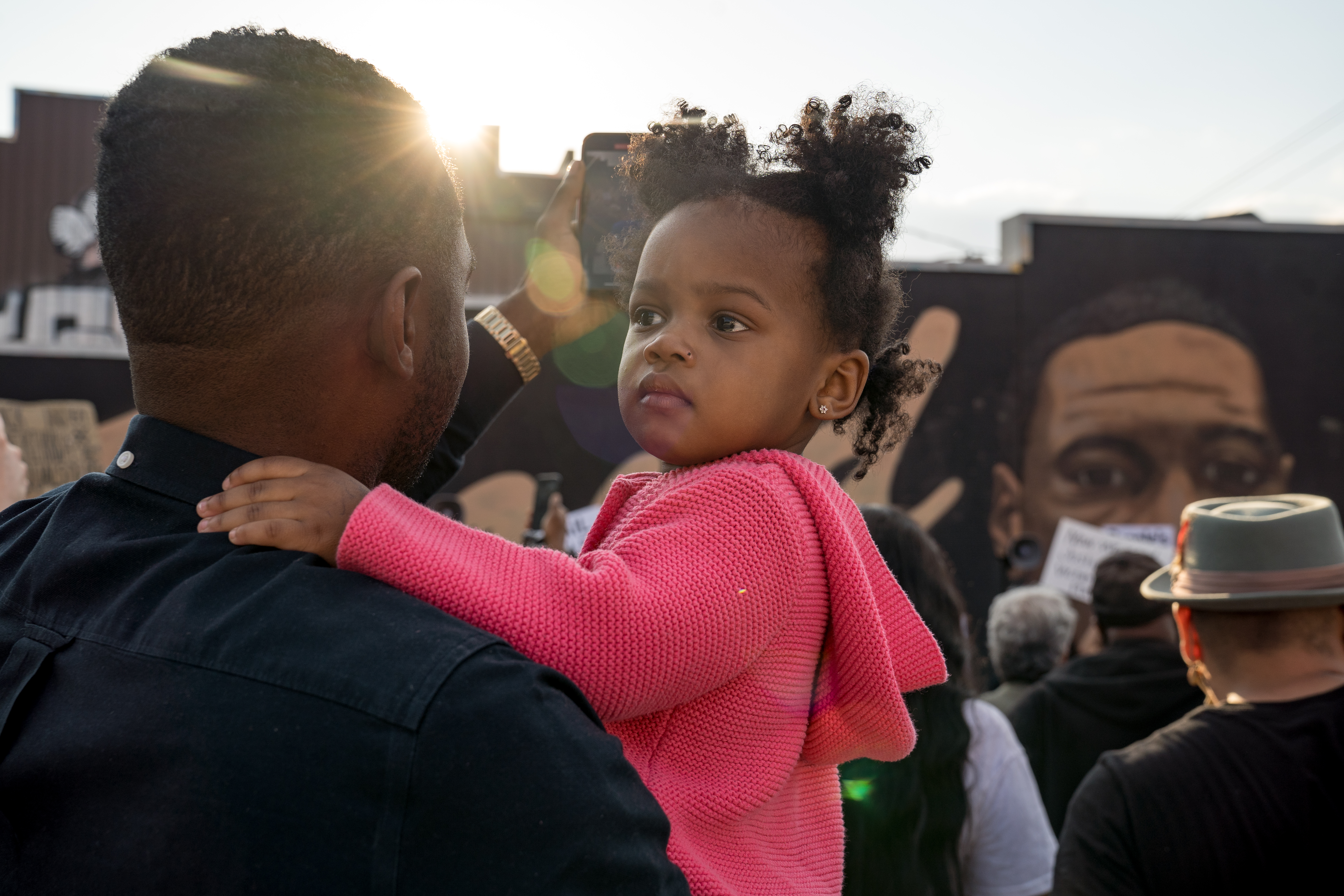 A child and her father attend a march in Minneapolis
