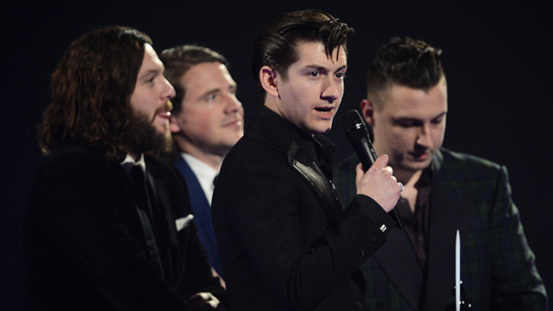 LONDON, ENGLAND - FEBRUARY 19:Alex Turner, Jamie Cook, Nick O&#039;Malley and Matt Helders of Arctic Monkeys receive the award for the MasterCard British Album of the Year at The BRIT Awards 2014 