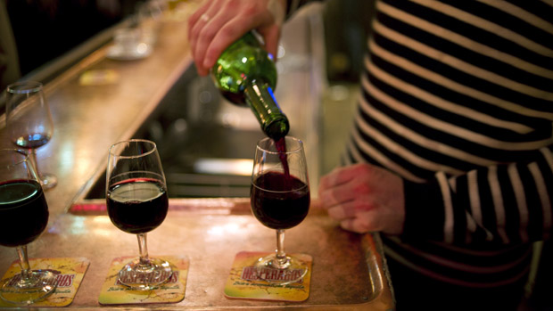 A waiter serves glasses of red wine at the counter of a bar on December 2, 2011 in Paris. AFP PHOTO / FRED DUFOUR(Photo credit should read FRED DUFOUR/AFP/Getty Images)