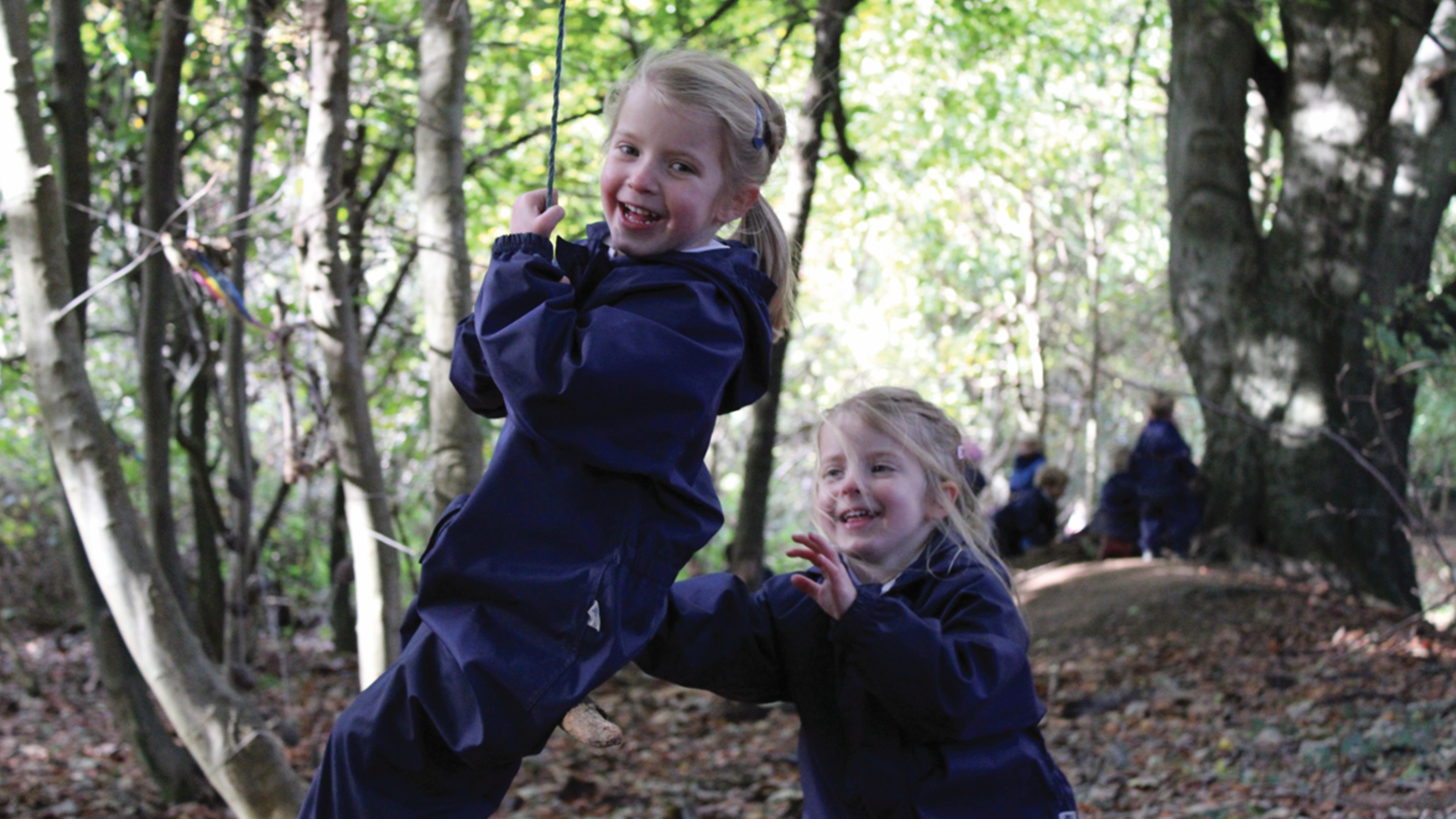 Children playing in the woodland at Elstree School