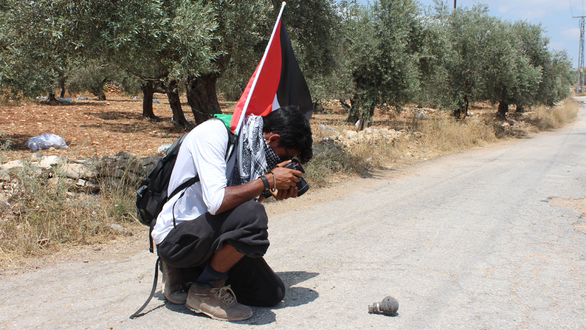 Adnan snaps a picture of a used stun grenade