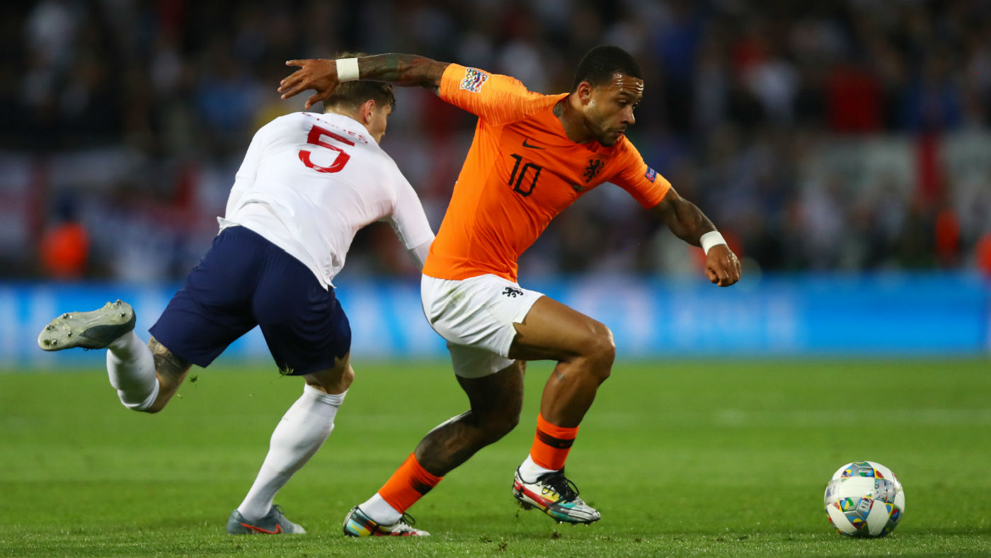 England defender John Stones loses the ball to Holland’s Memphis Depay
