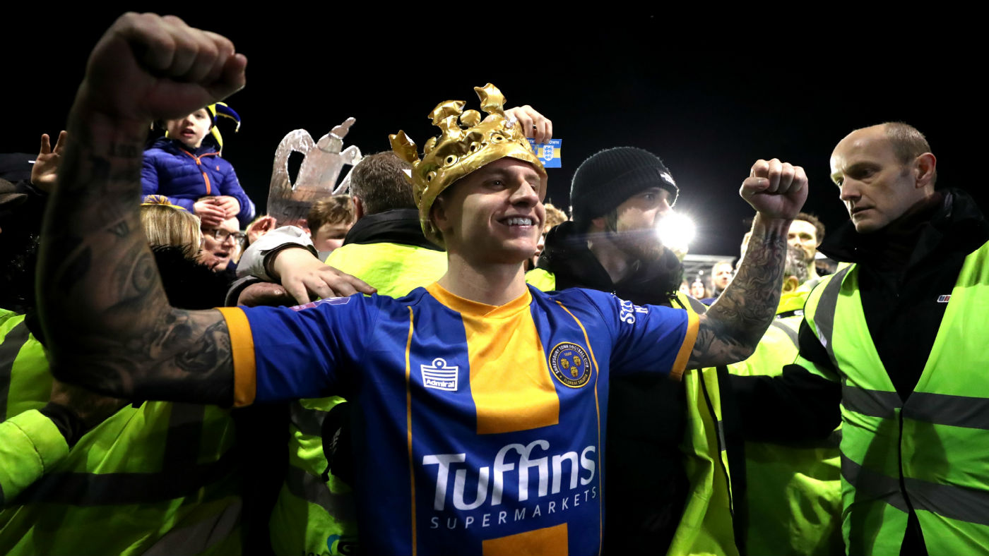 Shrewsbury Town striker Jason Cummings wears an inflatable crown after the 2-2 draw with Liverpool 