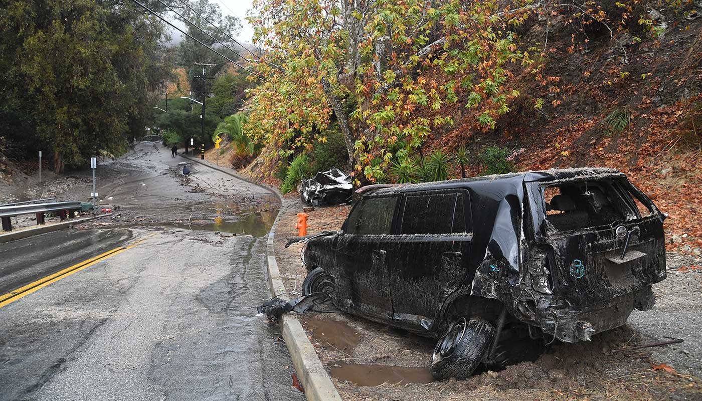 Two cars swept downhill by a powerful mudslide in southern California