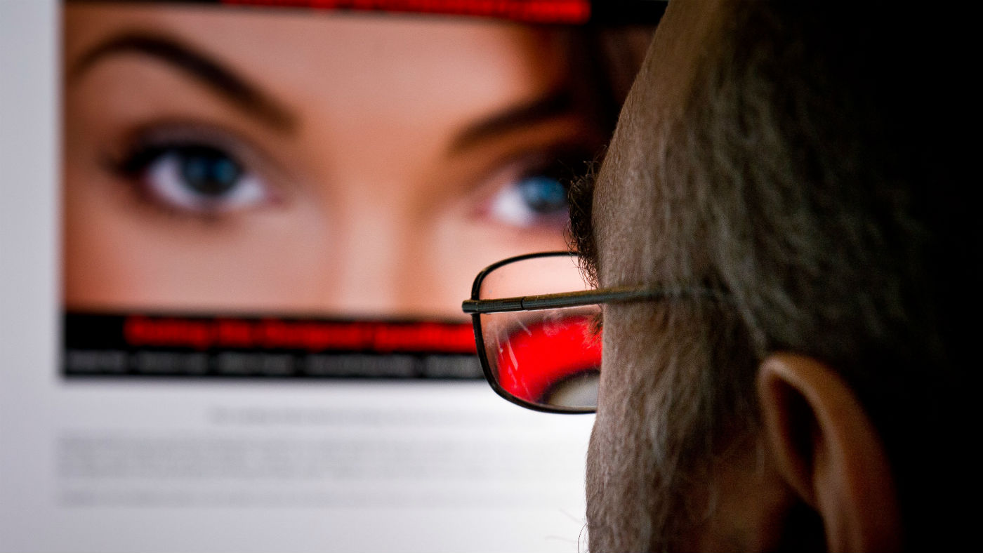 A man looks at hacked dating website Ashley Madison