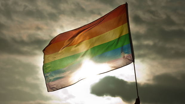 A person holds a rainbow flag during the Gay Pride Parade in San Salvador, El Salvador, on June 28, 2014. AFP PHOTO/ Jose CABEZAS(Photo credit should read JOSE CABEZAS/AFP/Getty Images)