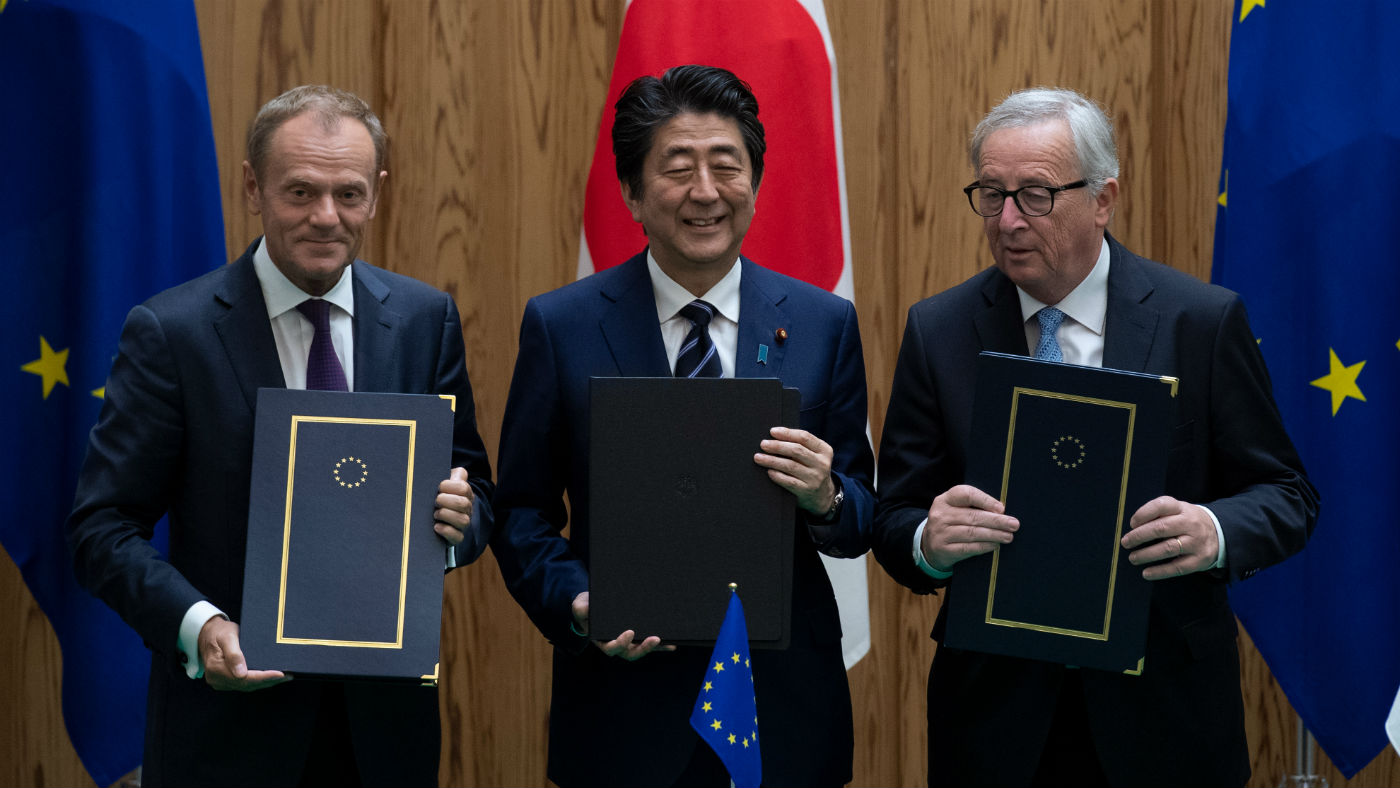 Donald Tusk, Shinzo Abe and Jean-Claude Junker sign the trade deal on Tuesday