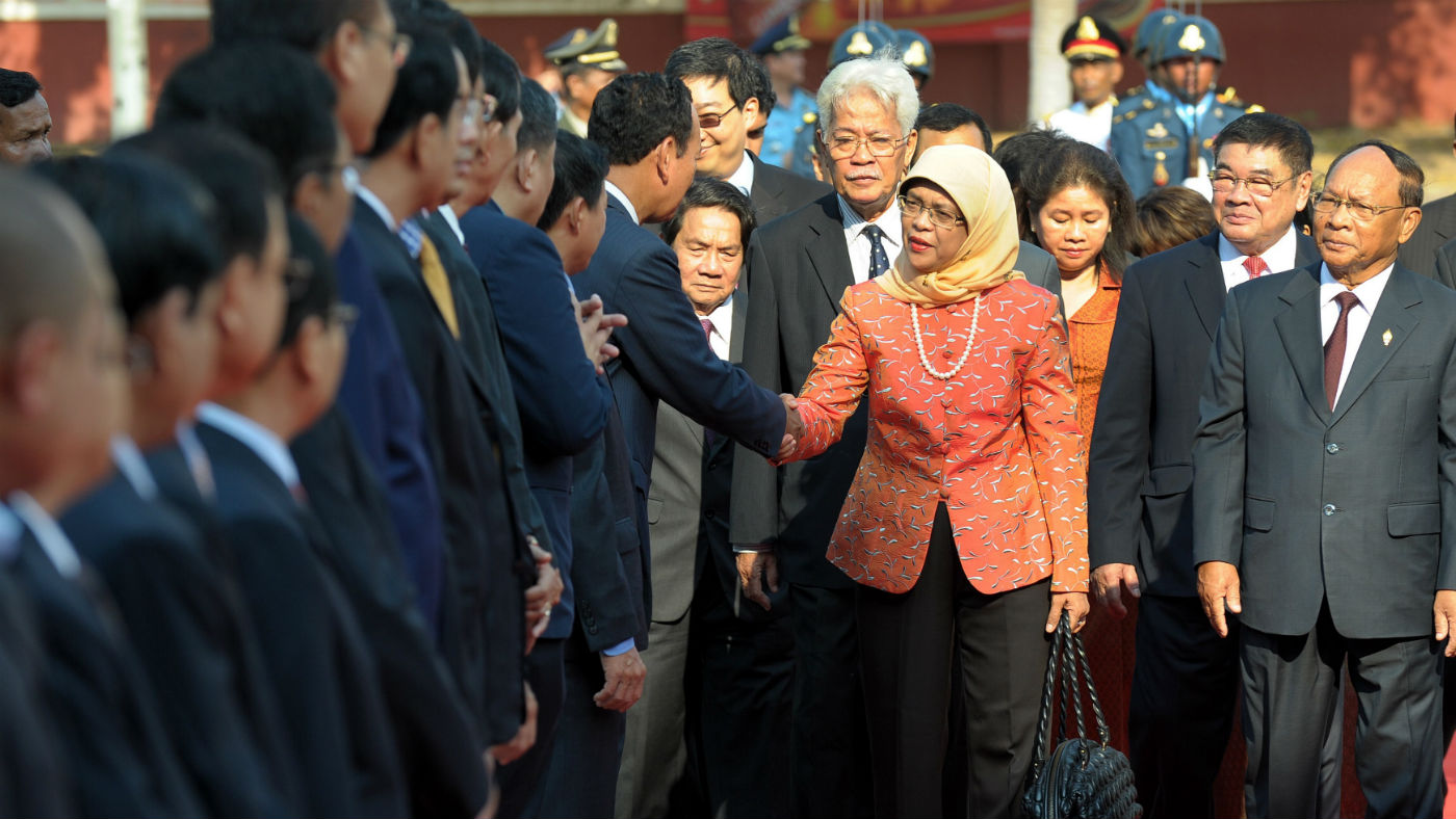 Halimah Yacob shakes hands with members of Singapore&#039;s parliament